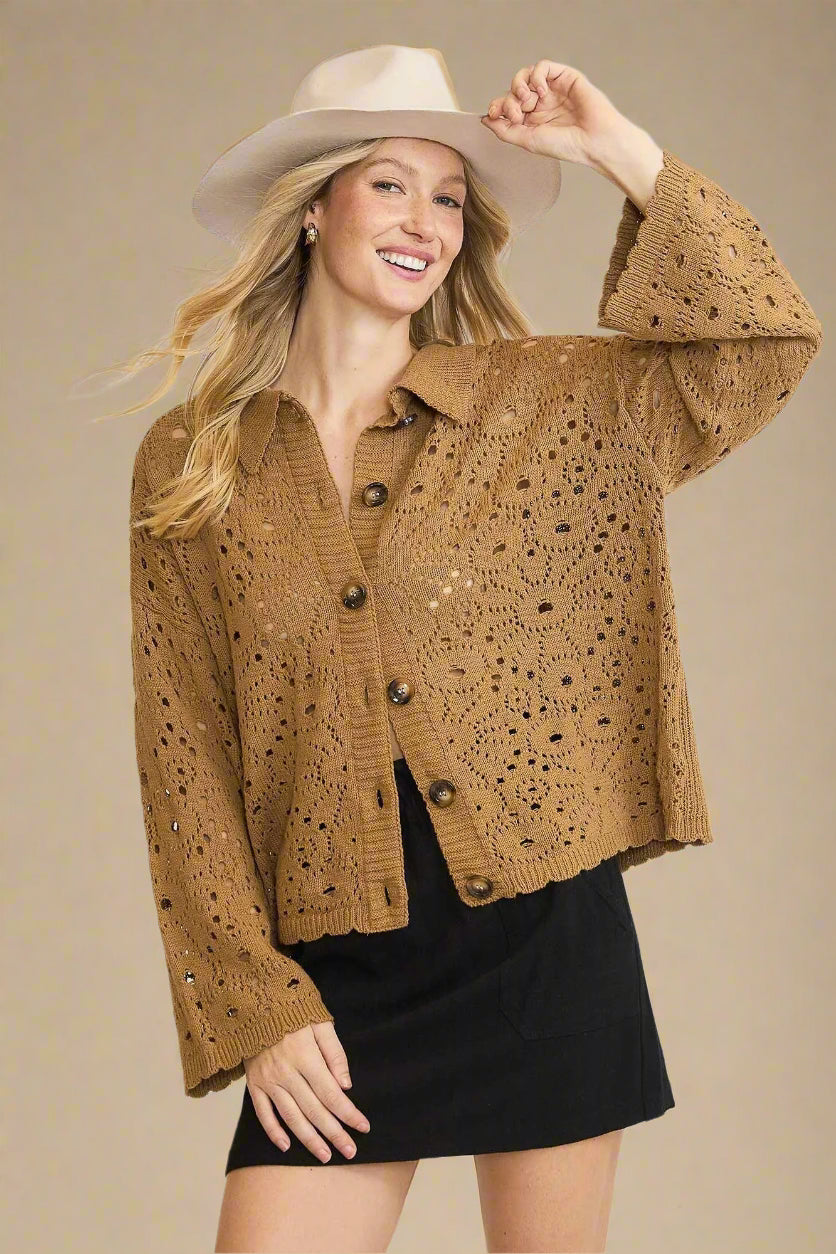 Woman wearing a brown crochet cardigan and beige hat on a beige background