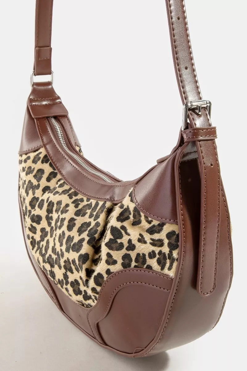 Brown handbag with leopard print section on a white background