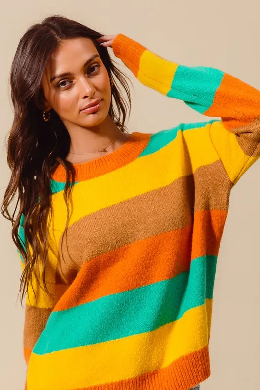 Woman wearing a colorful striped sweater against a beige background