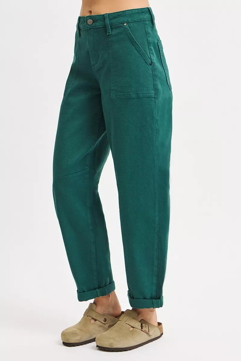 Green pants worn by a person on a white background
