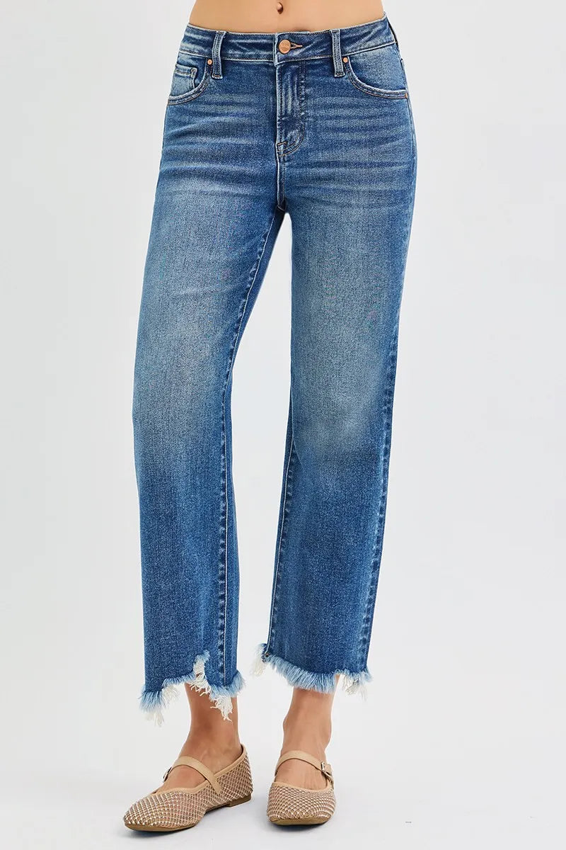Blue jeans with a frayed hem on a white background