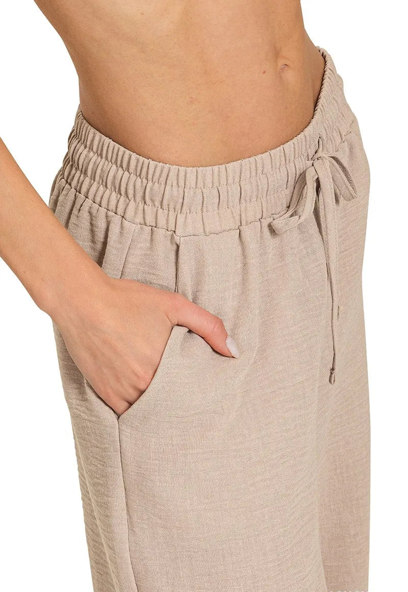 Beige pants with an elastic waistband on a white background