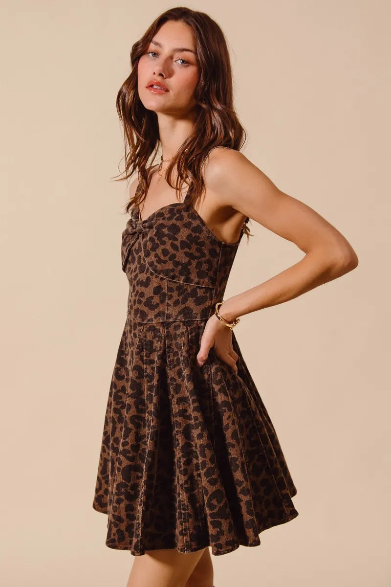 Woman wearing a leopard print dress against a beige background