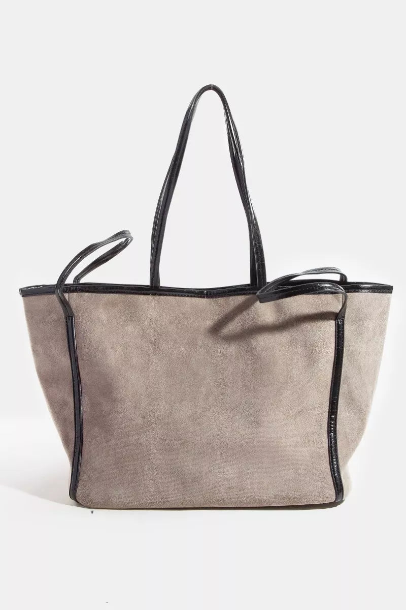 Beige tote bag with black accents on a white background