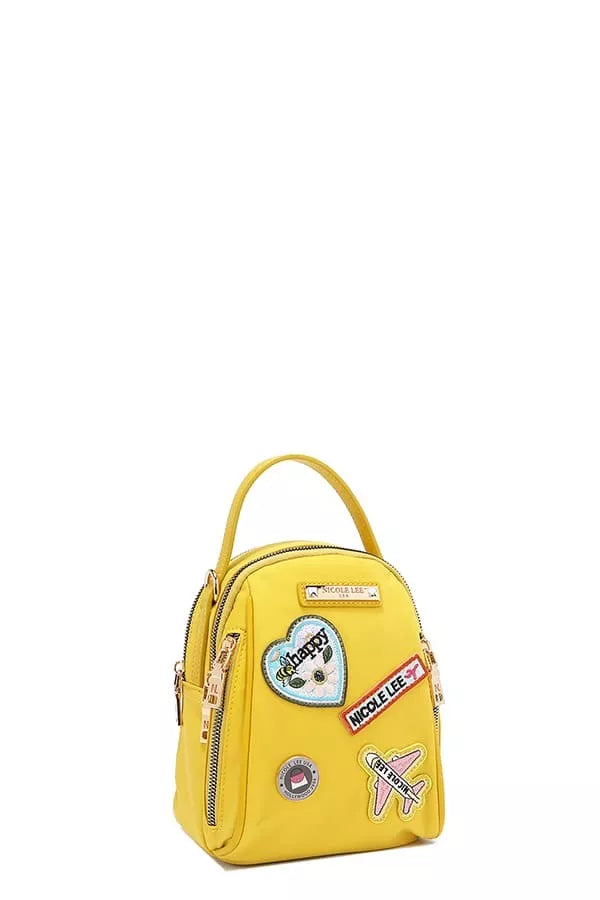 Yellow backpack with colorful patches on a white background