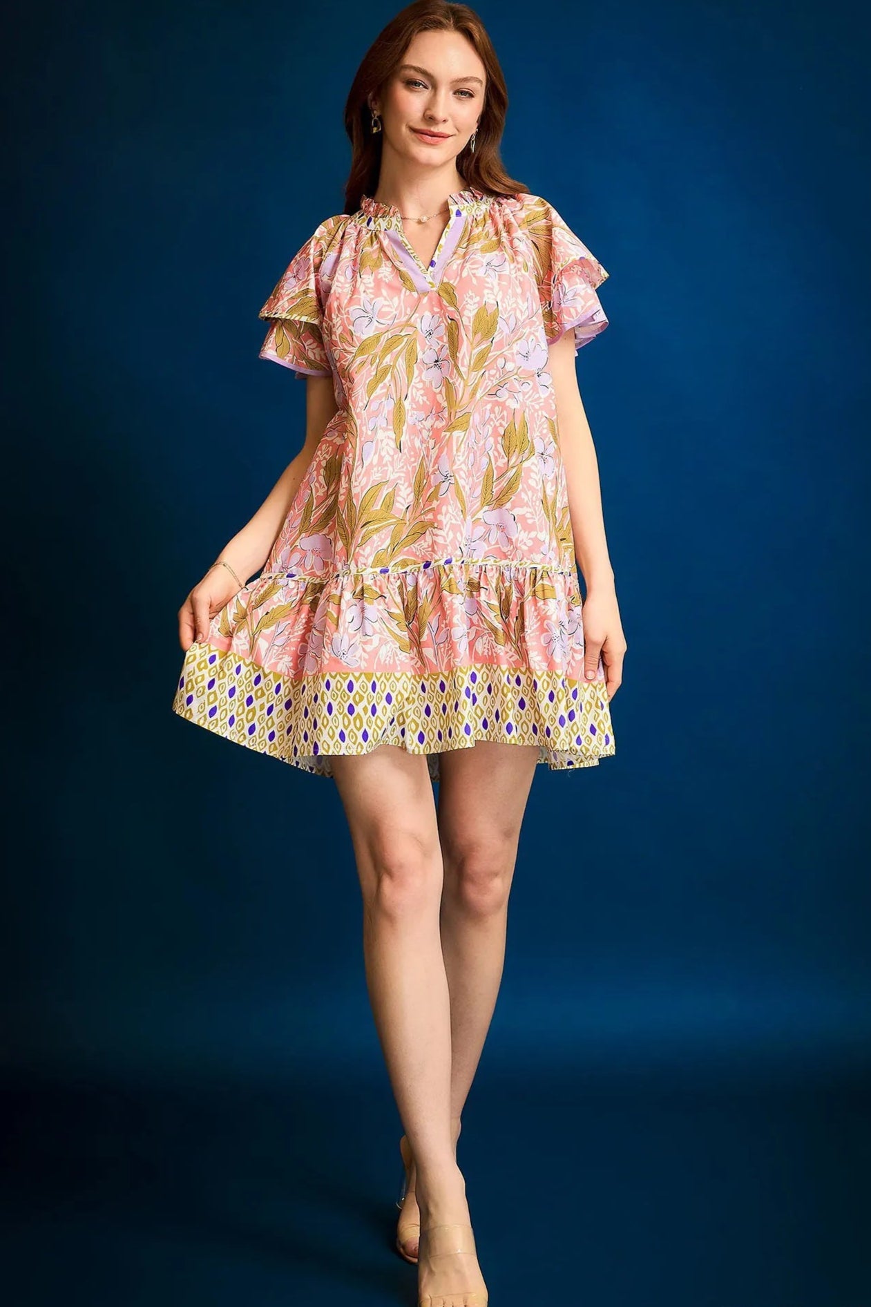 Woman wearing a floral dress against a blue background
