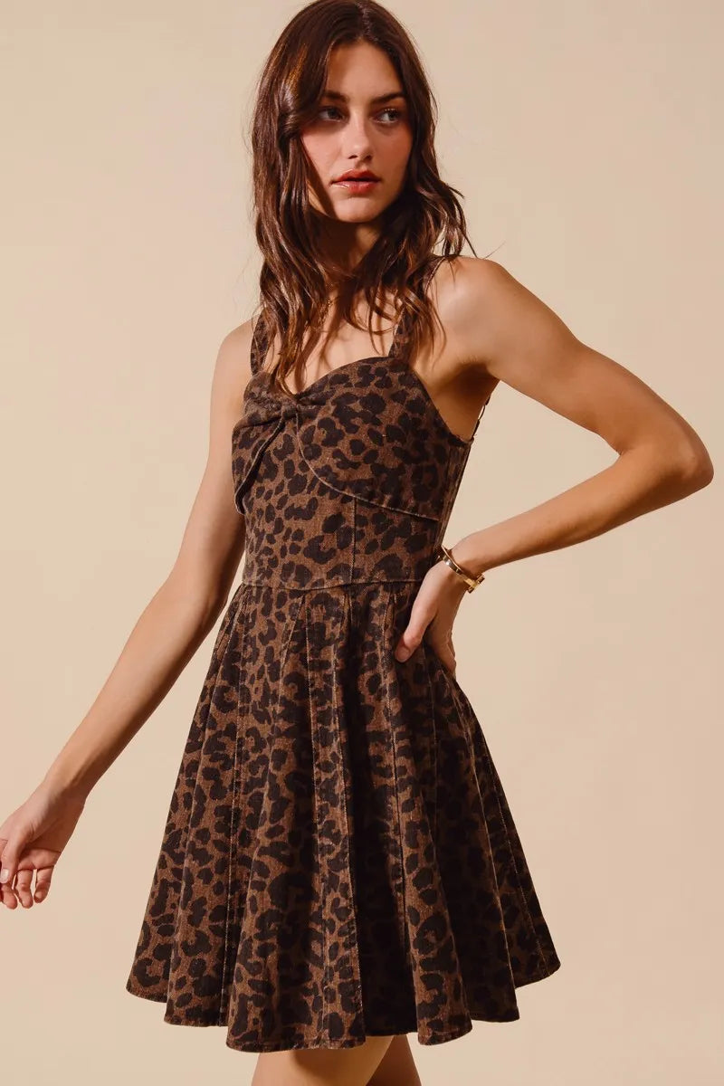 Woman wearing a leopard print dress against a beige background