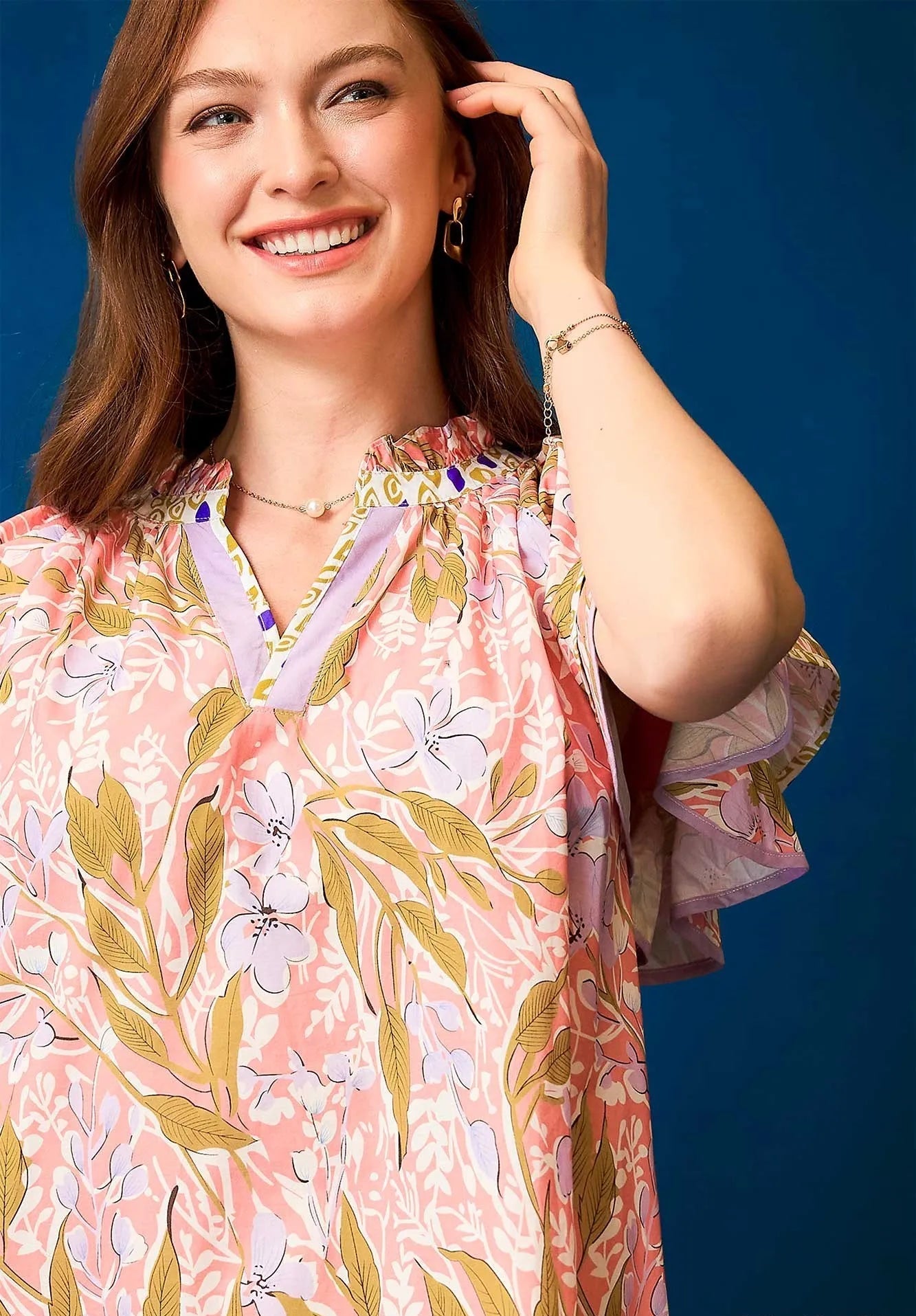 Woman wearing a floral dress with a blue background