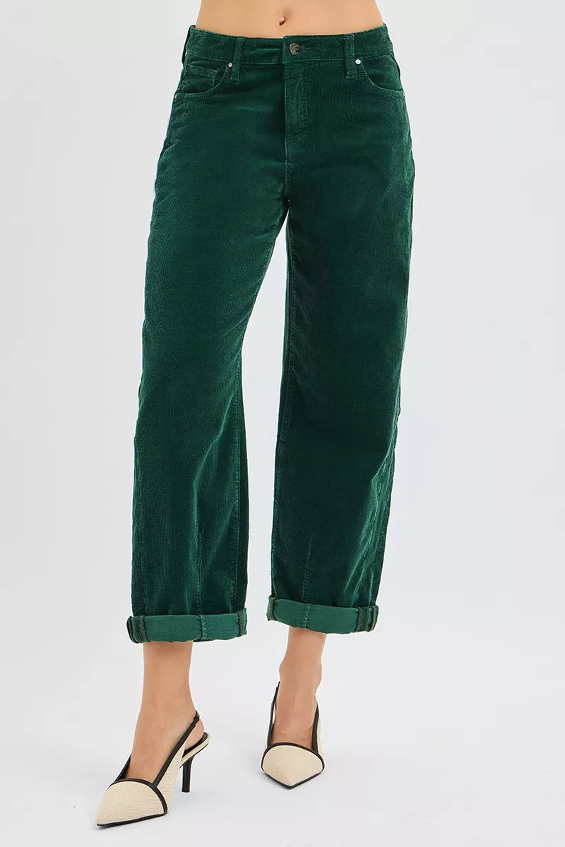 Green pants worn by a person on a white background