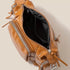 Brown leather bag with zippers on a beige background