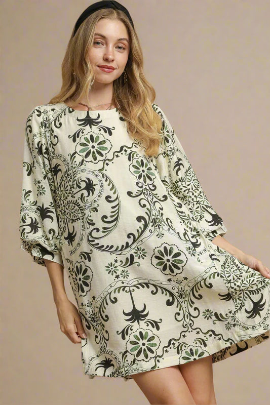 Woman wearing a patterned dress on a beige background