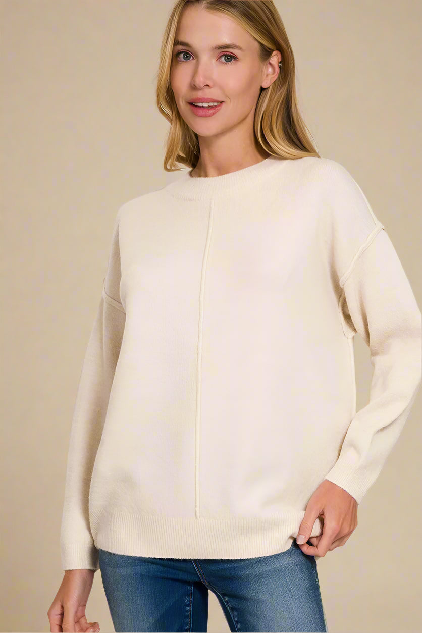 Woman wearing a sand beige sweater on a beige background