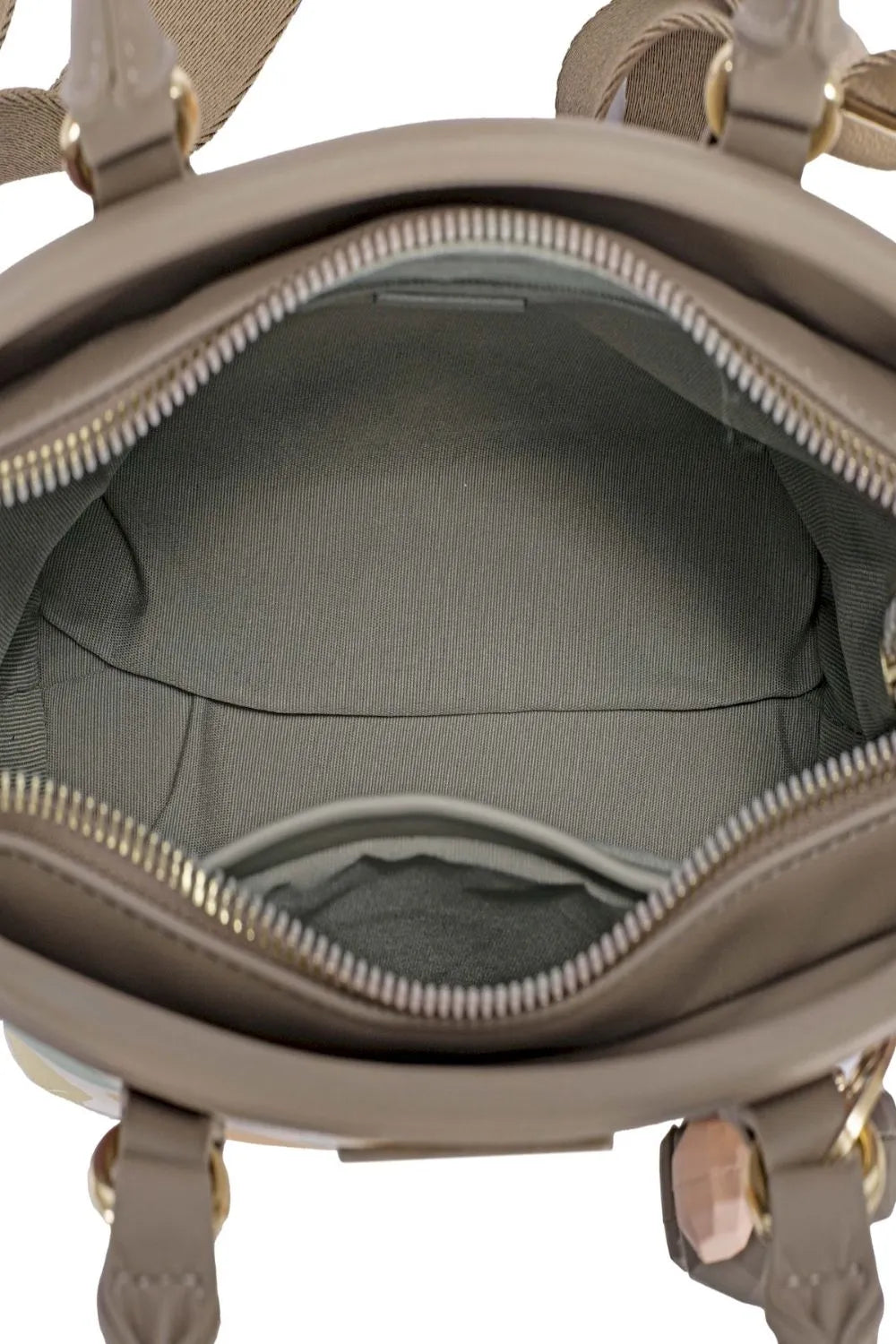 Close-up of a beige handbag with gold accents, showing the interior.