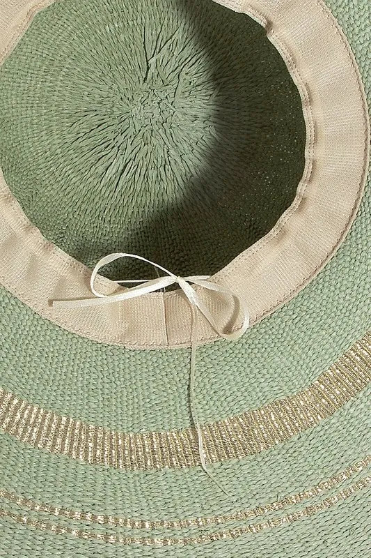 Close-up of a green straw hat with decorative trim