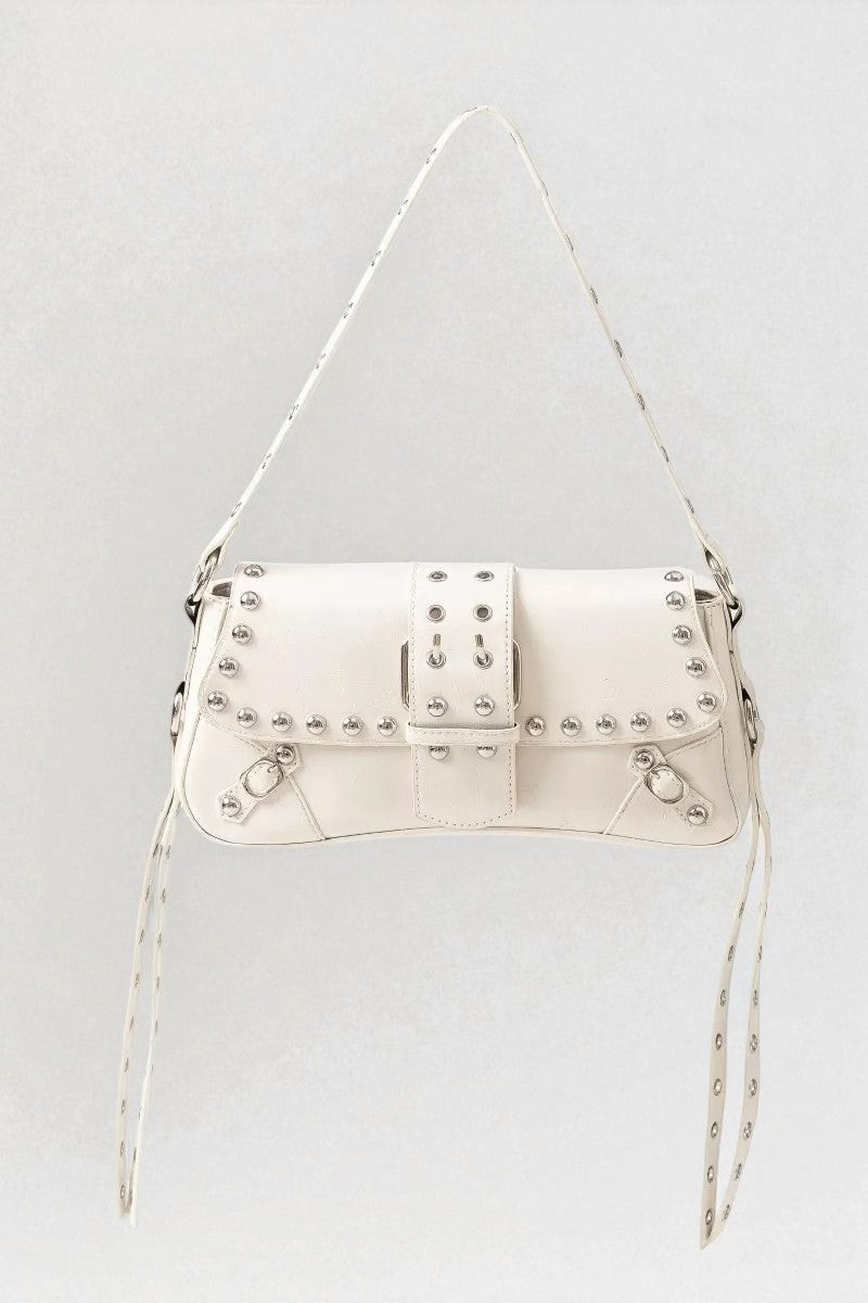White studded handbag on a light gray background