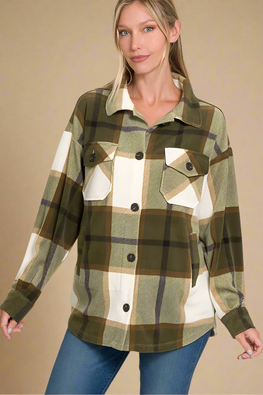 Woman wearing a plaid shirt with a beige background