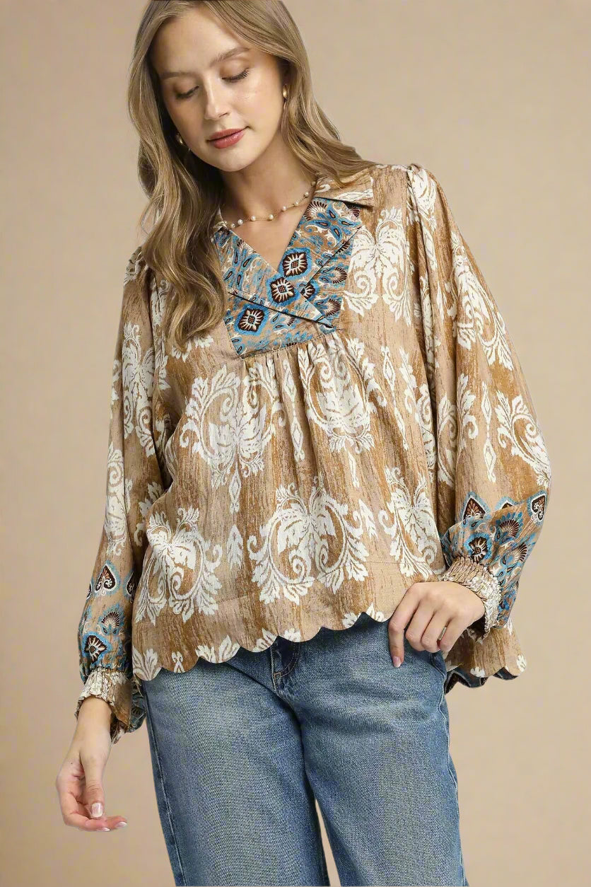 Woman wearing a patterned blouse with a neutral background