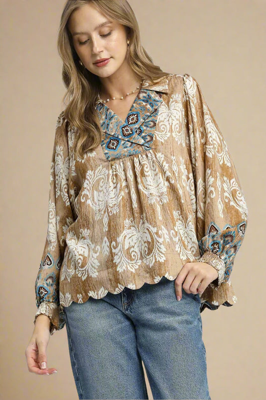 Woman wearing a patterned blouse with a neutral background