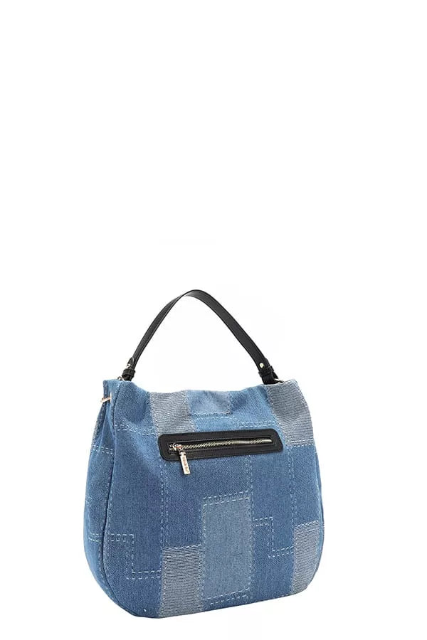 Blue denim patchwork handbag with a black handle on a white background