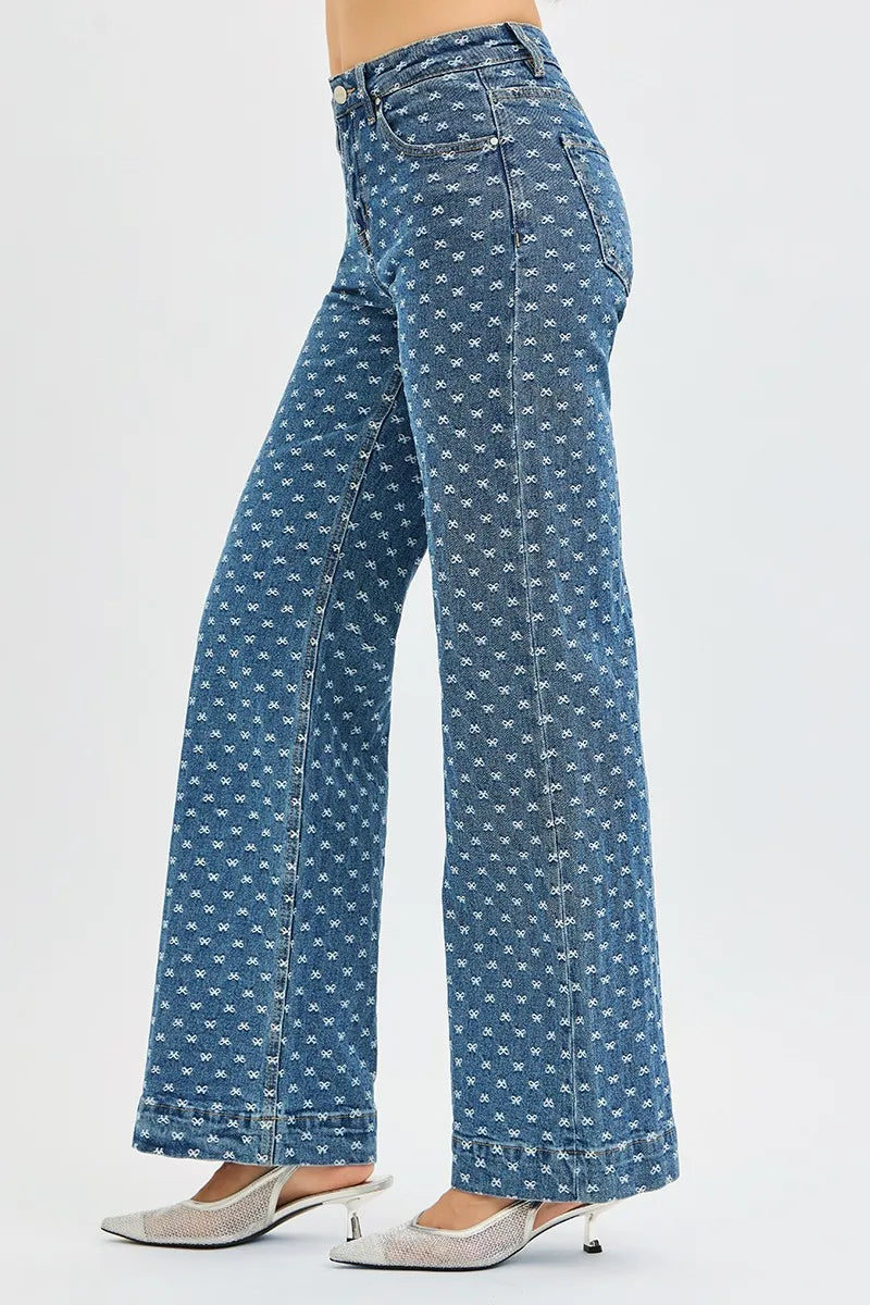 Blue patterned jeans worn by a person on a white background