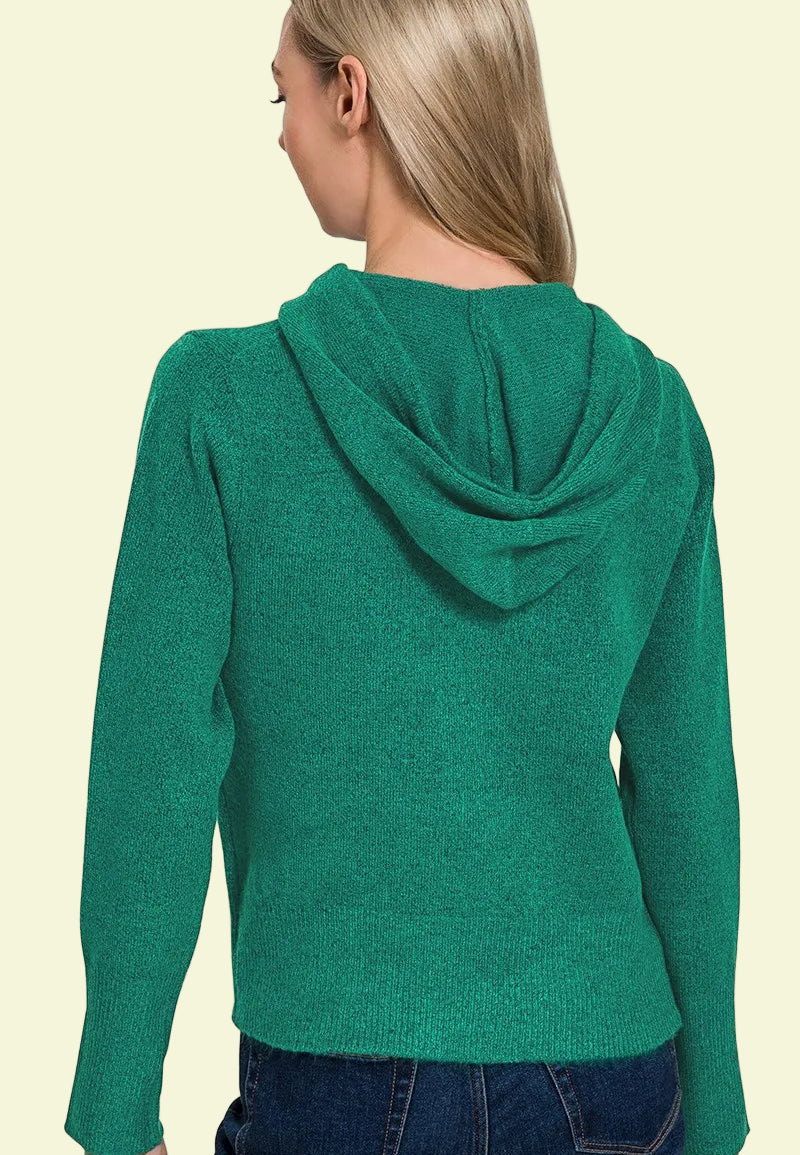 Person wearing a green hoodie on a beige background