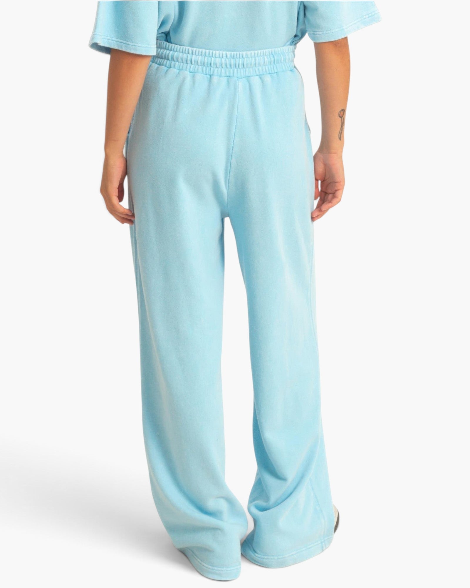Beach Rose Co. light blue acid wash French terry wide-leg pants with an elastic drawstring waistband, back view.