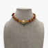 Beach Rose Co. 18K gold-plated necklace featuring amber-tone resin beads and a polished gold-tone center bead.