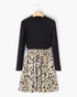 Beach Rose Co. black ribbed mock neck long sleeve dress with a beige animal print flared skirt and waist tie.