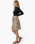 Beach Rose Co. black ribbed mock neck dress with a beige animal print flared skirt and matching waist tie.