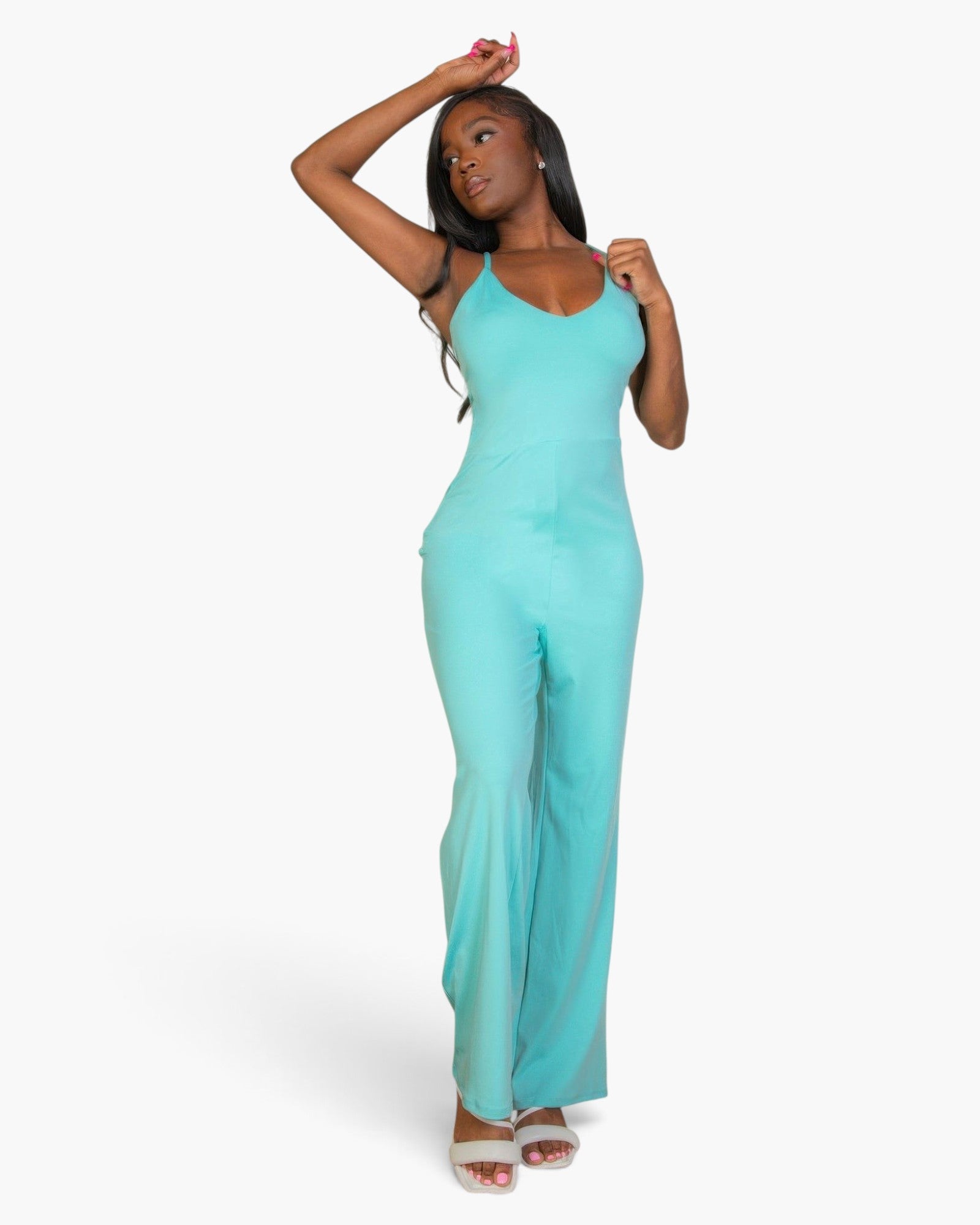 Beach Rose Co. aqua V-neck camisole jumpsuit in soft stretch knit worn by a model with white sandals