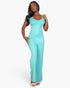 Beach Rose Co. aqua V-neck camisole jumpsuit in soft stretch knit fabric worn by a model on a white background