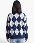 Beach Rose Co. relaxed fit navy and white argyle sweater with a ribbed hem worn by a model, back view.