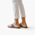 Beach Rose Co. Aria Up flat slip-on shoes in cream and mauve with a textured rubber sole worn with white trousers