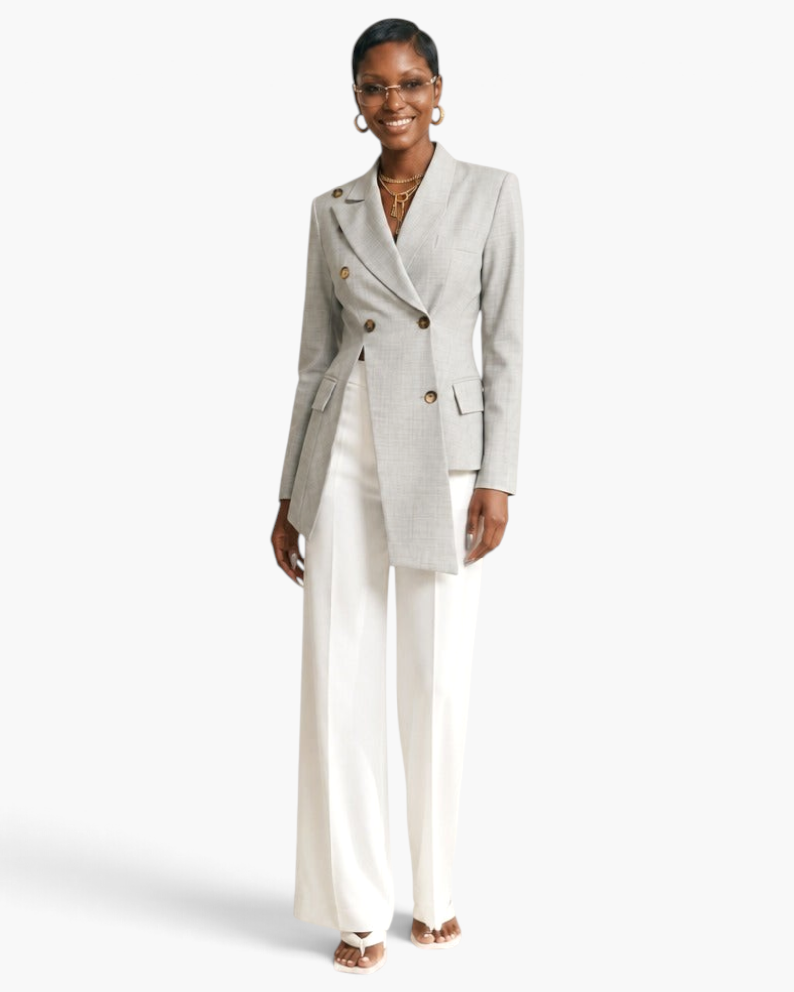 Beach Rose Co. light gray asymmetrical double-breasted blazer with notched lapels worn by a model with white trousers