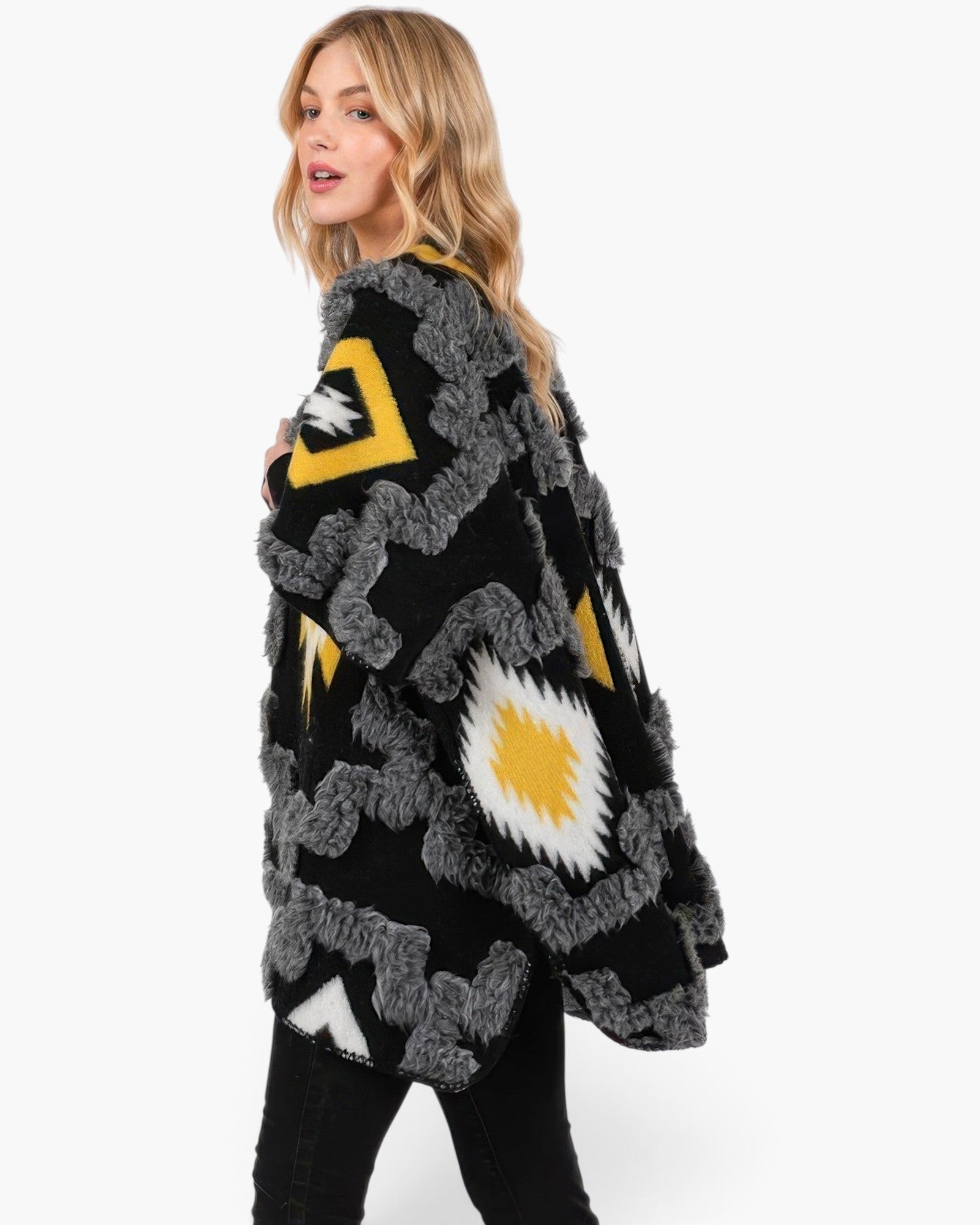 Beach Rose Co. fuzzy Aztec print open-front ruana with yellow and black geometric patterns on a blonde model