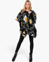 Beach Rose Co. fuzzy Aztec open-front ruana in black, white, and yellow with dimensional trim on a blonde model.