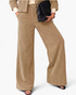 Beach Rose Co. beige corduroy wide leg pants and matching button-front jacket set with a black handbag