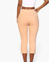 Beach Rose Co. beige cropped pants with elastic waist and slit hem worn by a model on a white background