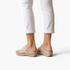 Beach Rose Co. beige thong wedge sandals with cutout details and gold accents worn with white cropped pants