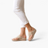 Beach Rose Co. beige thong wedge sandals with decorative cutouts and gold accents worn with white cropped pants