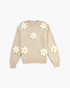 Beach Rose Co. beige knit sweater featuring dimensional white daisy appliqués with yellow centers and a crew neckline.