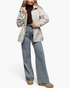 Beach Rose Co. beige hooded jacket with drawstring waist, zip front, and snap placket worn by a model with jeans.