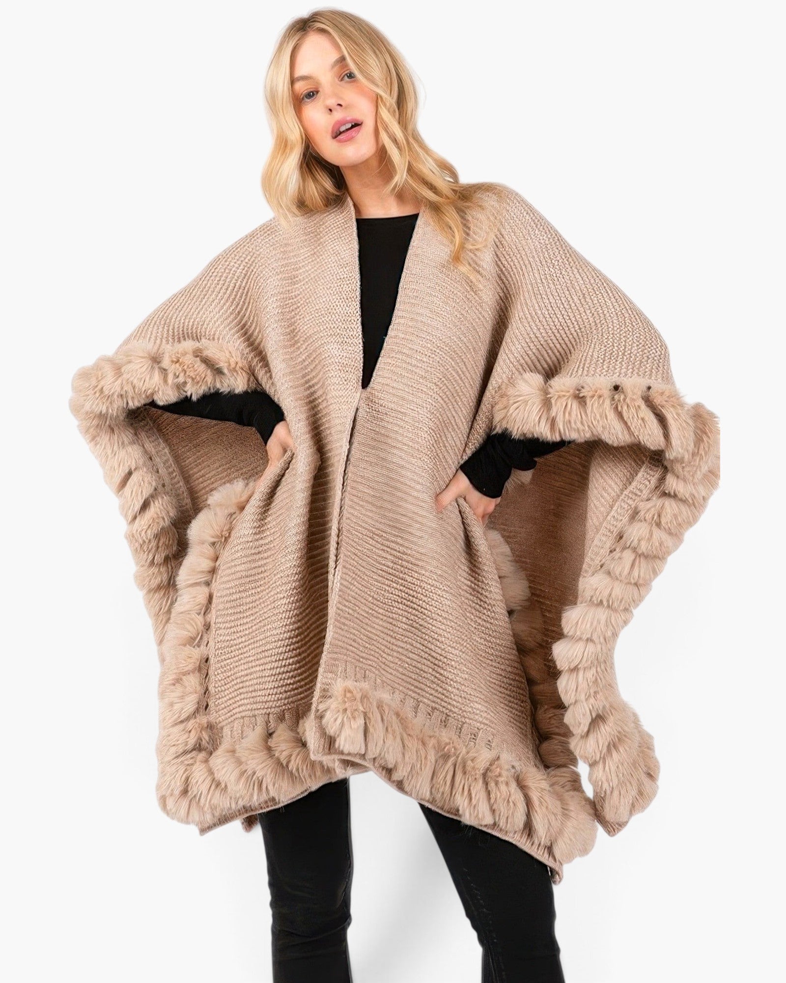 Beach Rose Co. beige knit cape with plush faux fur trim and front clasp closure worn by a blonde model