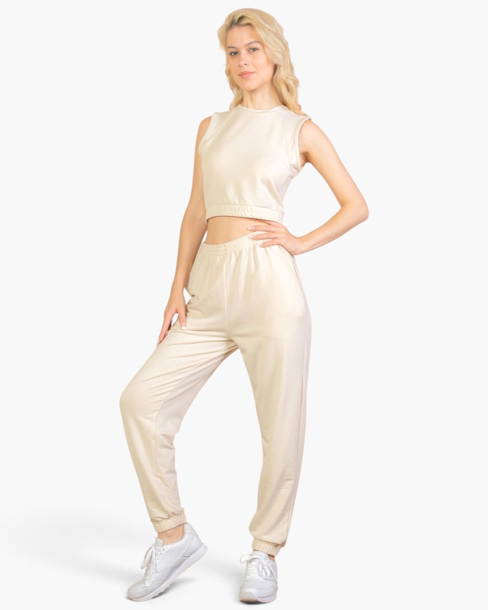 Beach Rose Co. beige French Terry tank top and jogger set worn by a blonde model with white sneakers.
