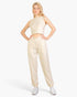 Beach Rose Co. beige French Terry tank top and joggers set worn by a blonde model with white sneakers