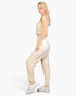Beach Rose Co. beige French terry tank top and joggers set worn by a blonde model in a side profile view.