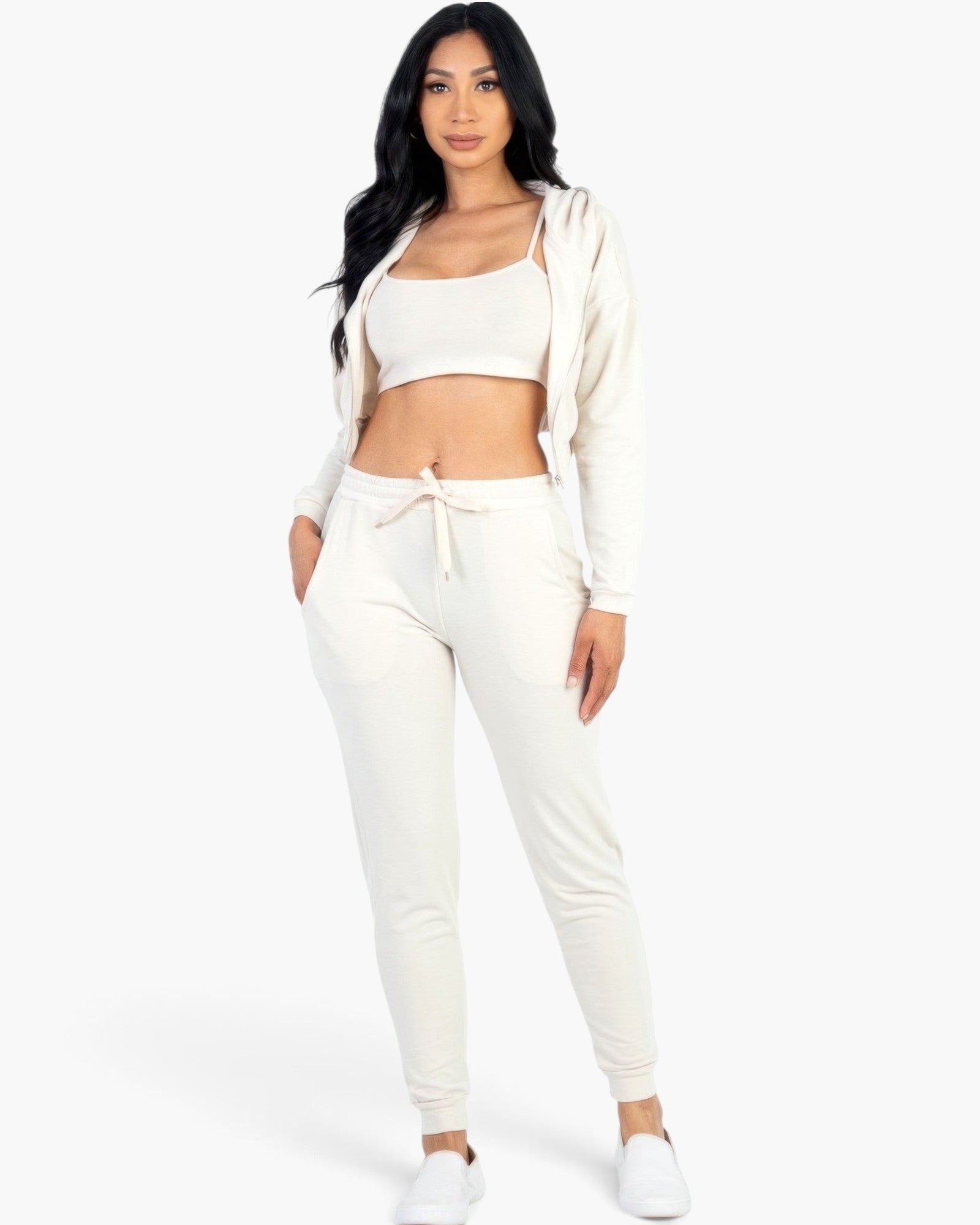 Beach Rose Co. beige French terry three-piece set with a cropped cami, zip-up jacket, and tapered joggers on a model.
