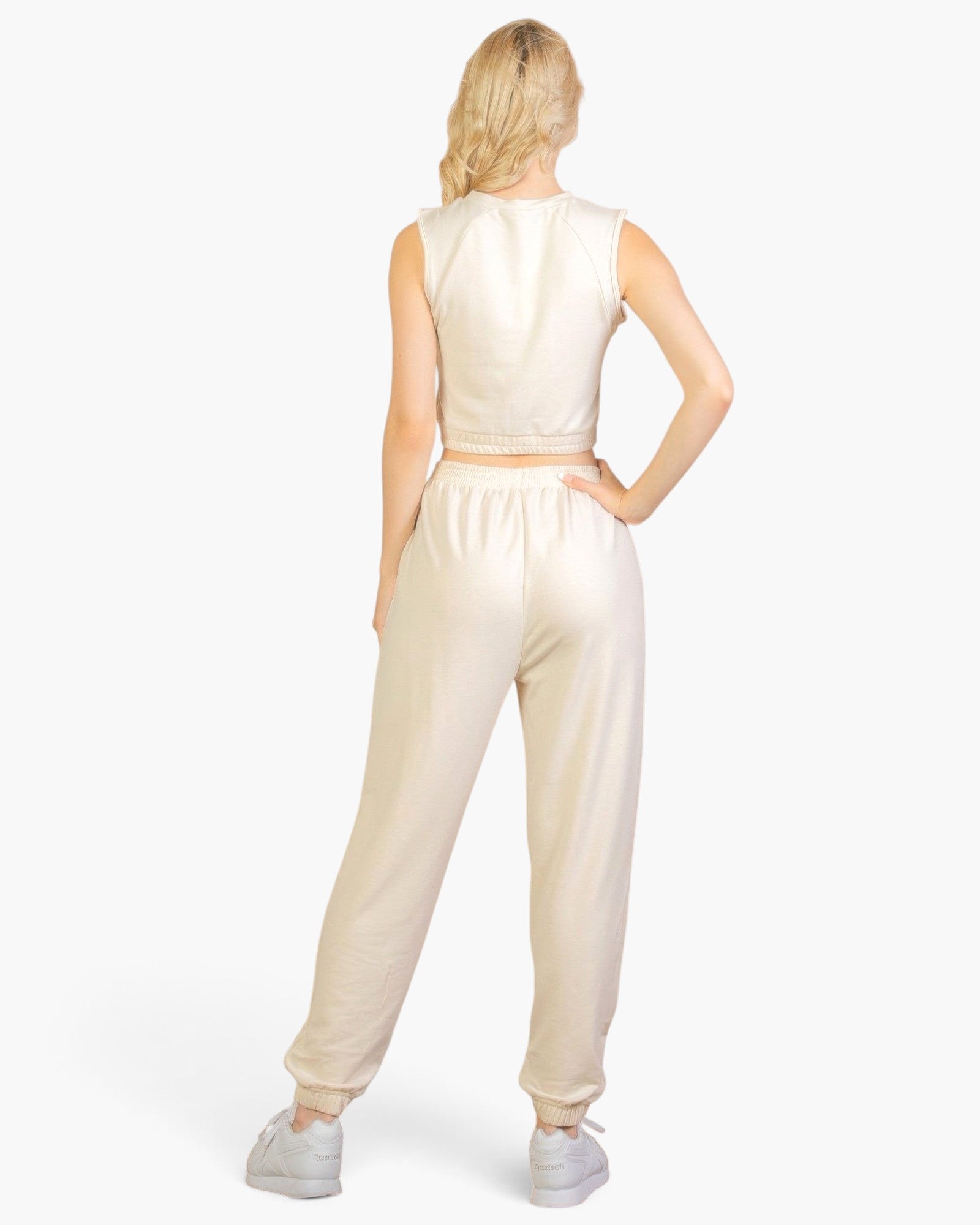 Beach Rose Co. beige French Terry tank top and joggers set worn by a blonde woman, back view.