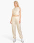 Beach Rose Co. beige French Terry tank top and joggers set worn by a blonde model with white sneakers