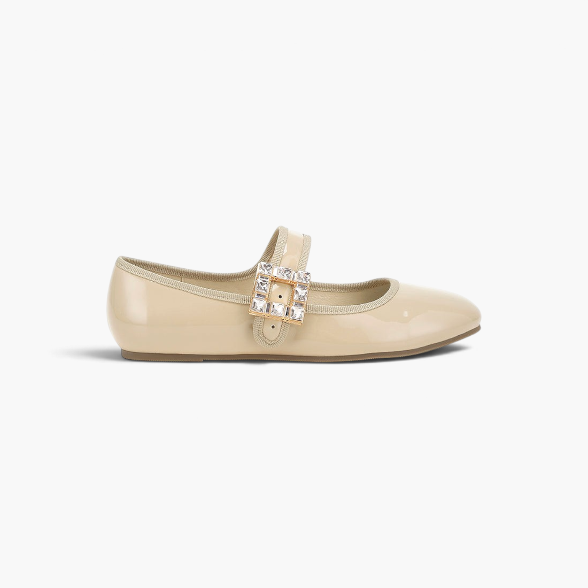 Beach Rose Co. beige glossy Mary Jane flats with a jewel-embellished buckle strap and a rounded toe.